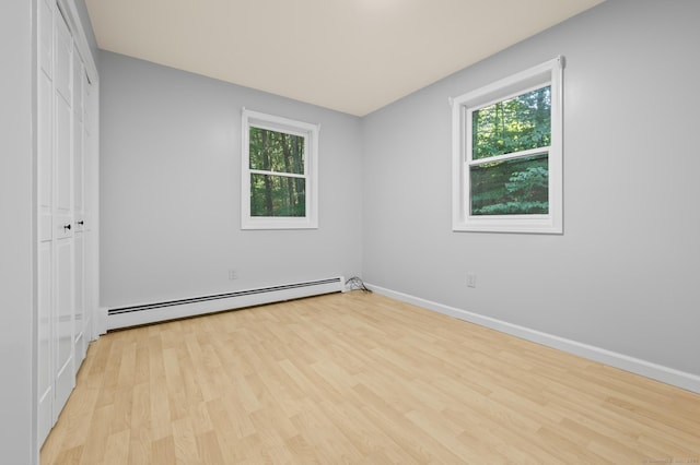7 Woodmont Rd, Avon, CT 06001 - unfurnished bedroom with baseboard heating, multiple windows, light wood-style flooring, and a closet