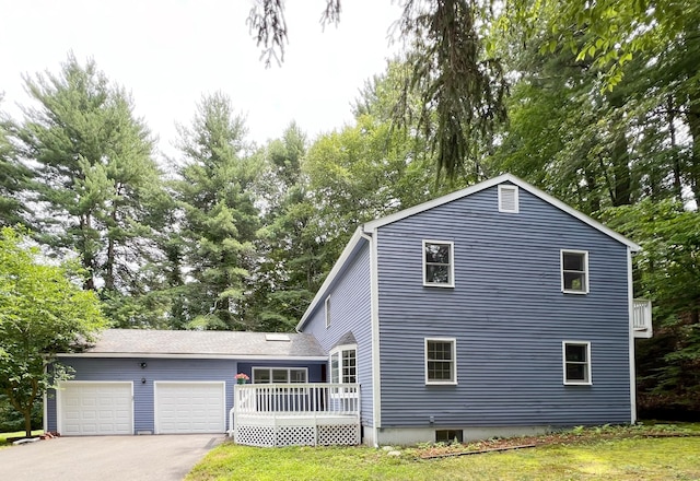 7 Woodmont Rd, Avon, CT 06001 - view of front of property featuring a garage, a wooden deck, driveway, view of wooded area, and a front yard