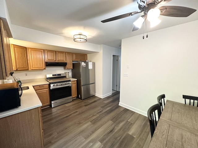 63 Coleman St Apt 14, East Haven, CT 06512 - kitchen with appliances with stainless steel finishes, range hood, light countertops, dark wood-style floors, and a ceiling fan
