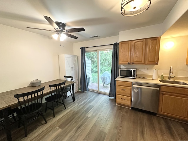63 Coleman St Apt 14, East Haven, CT 06512 - kitchen with stainless steel appliances, dark wood-style flooring, a ceiling fan, light countertops, and brown cabinetry