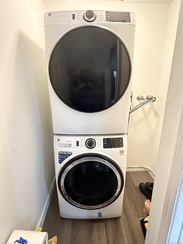 63 Coleman St Apt 14, East Haven, CT 06512 - laundry area with stacked washer / dryer and wood finished floors