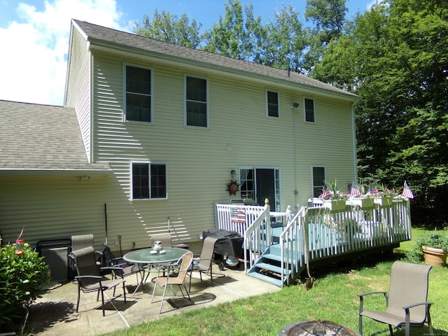 26 Julia Ln, Thomaston, CT 06787 - rear view of property featuring a fire pit, a wooden deck, a patio area, roof with shingles, and a lawn