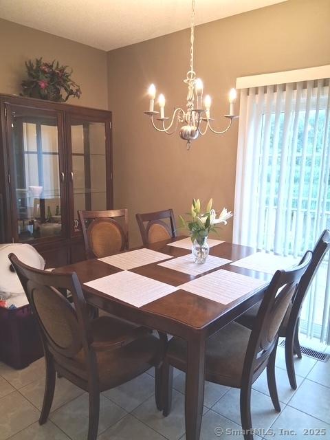3 Holly Ln Unit 3, Farmington, CT 06085 - dining space featuring healthy amount of natural light, a chandelier, and light tile patterned flooring