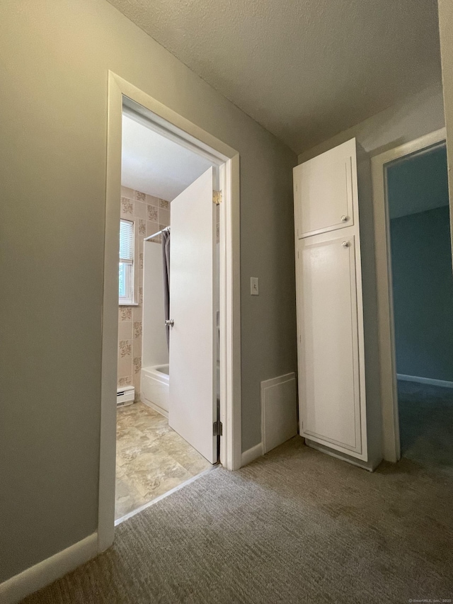 56 Elm St Apt 36, Enfield, CT 06082 - unfurnished bedroom featuring carpet flooring, a baseboard radiator, and ensuite bath
