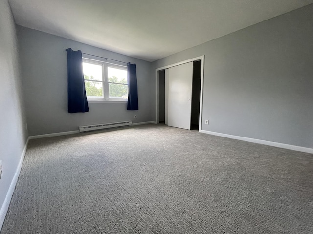 56 Elm St Apt 36, Enfield, CT 06082 - unfurnished bedroom with baseboard heating, a closet, and carpet floors