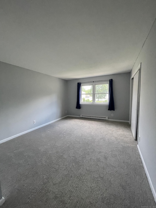 56 Elm St Apt 36, Enfield, CT 06082 - unfurnished room featuring a baseboard radiator and carpet floors