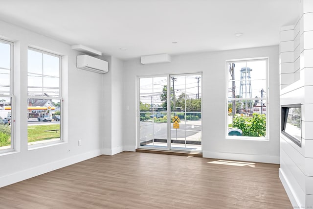 32 Broadway Ave, Stonington, CT 06355 - empty room featuring an AC wall unit and wood finished floors
