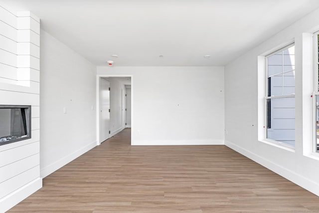 32 Broadway Ave, Stonington, CT 06355 - unfurnished living room with light wood-style floors and a large fireplace