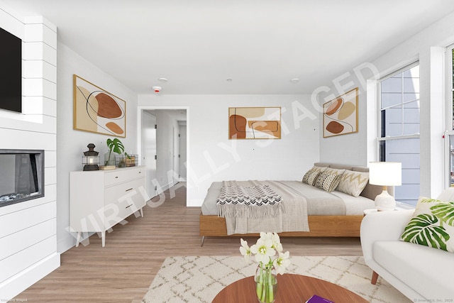 32 Broadway Ave, Stonington, CT 06355 - bedroom featuring light wood-style flooring and a glass covered fireplace