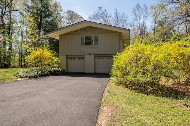 87 Pleasant Dr, Bethany, CT 06524 - view of home's exterior with asphalt driveway, a garage, and stucco siding