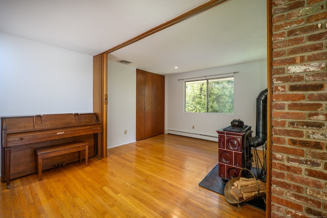 87 Pleasant Dr, Bethany, CT 06524 - unfurnished living room with a baseboard heating unit, wood finished floors, a wood stove, and recessed lighting