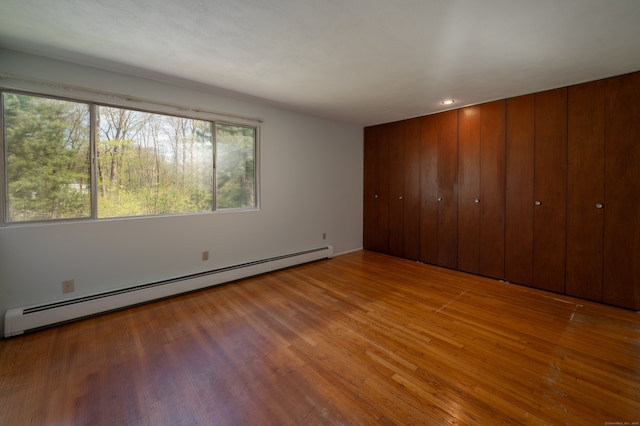 87 Pleasant Dr, Bethany, CT 06524 - unfurnished bedroom featuring a baseboard radiator and wood finished floors