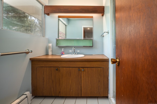 87 Pleasant Dr, Bethany, CT 06524 - bathroom featuring a baseboard heating unit, vanity, and tile patterned floors