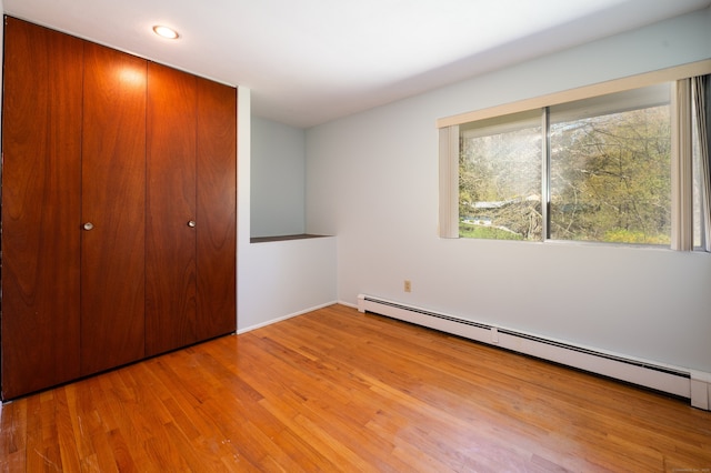 87 Pleasant Dr, Bethany, CT 06524 - unfurnished bedroom featuring a baseboard heating unit, light wood-style floors, a closet, and recessed lighting