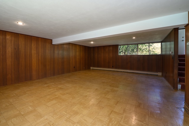 87 Pleasant Dr, Bethany, CT 06524 - spare room with a baseboard radiator, wooden walls, and light flooring