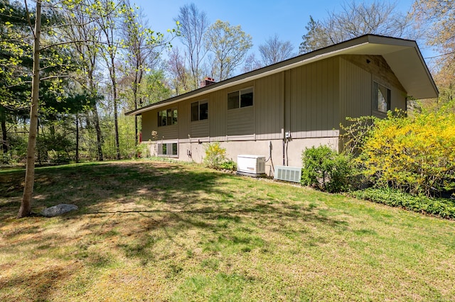 87 Pleasant Dr, Bethany, CT 06524 - view of property exterior featuring a lawn and a chimney