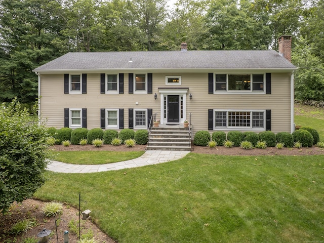 58 Longmeadows Rd, Wilton, CT 06897 - split foyer home with a chimney, a front lawn, and view of wooded area