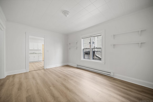 220 Hillside Ave, Waterbury, CT 06710 - spare room featuring a baseboard heating unit, crown molding, and light wood-type flooring