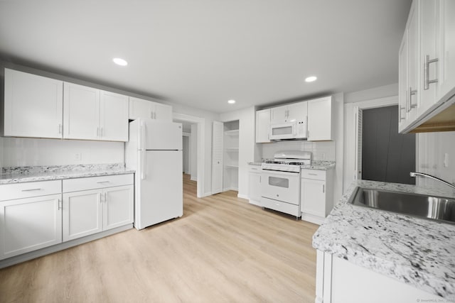 220 Hillside Ave, Waterbury, CT 06710 - kitchen featuring white appliances, recessed lighting, white cabinetry, light wood finished floors, and light stone countertops