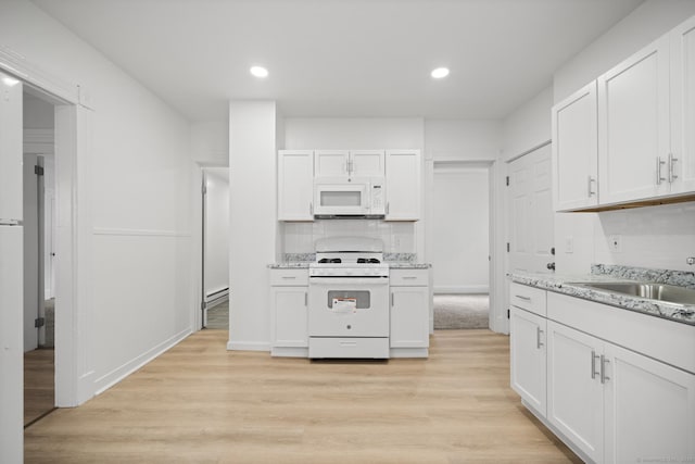 220 Hillside Ave, Waterbury, CT 06710 - kitchen with white appliances, white cabinetry, light wood finished floors, recessed lighting, and backsplash