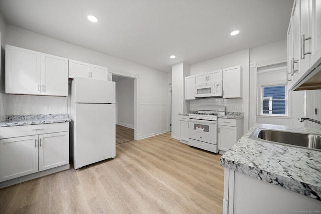 220 Hillside Ave, Waterbury, CT 06710 - kitchen with white appliances, white cabinets, light wood finished floors, recessed lighting, and light stone counters