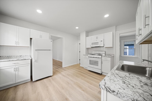 220 Hillside Ave, Waterbury, CT 06710 - kitchen with white appliances, white cabinets, light wood-type flooring, and recessed lighting