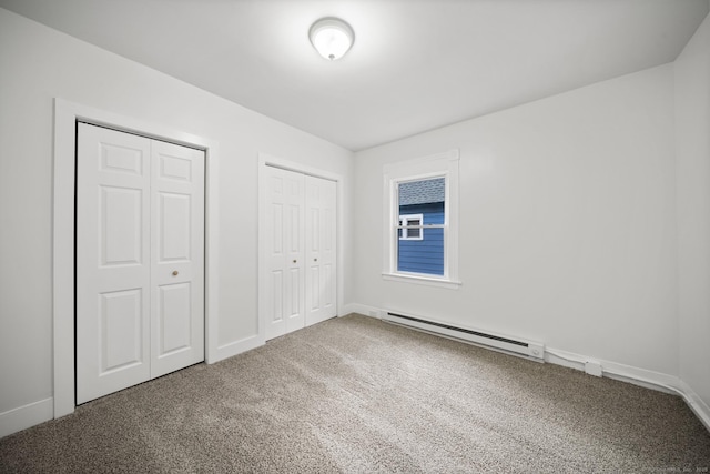 220 Hillside Ave, Waterbury, CT 06710 - unfurnished bedroom with baseboard heating, multiple closets, and carpet