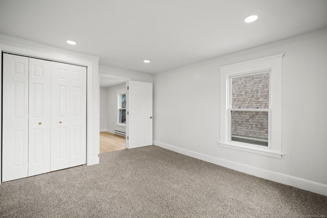 220 Hillside Ave, Waterbury, CT 06710 - unfurnished bedroom featuring light colored carpet, recessed lighting, a closet, and a baseboard radiator