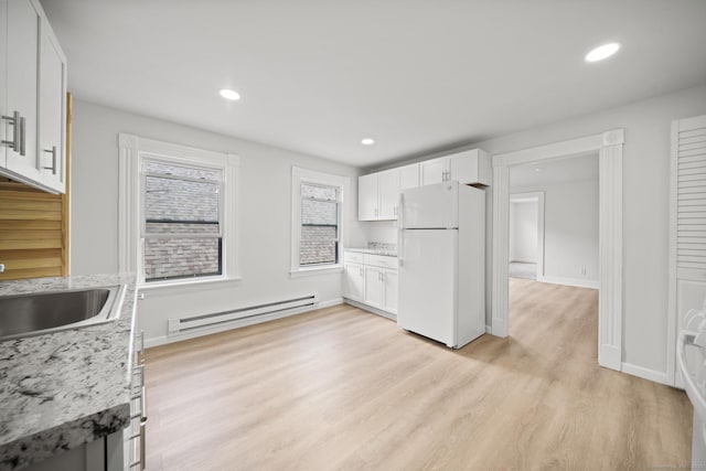 220 Hillside Ave, Waterbury, CT 06710 - kitchen with freestanding refrigerator, a baseboard radiator, light wood-style floors, white cabinetry, and light stone countertops