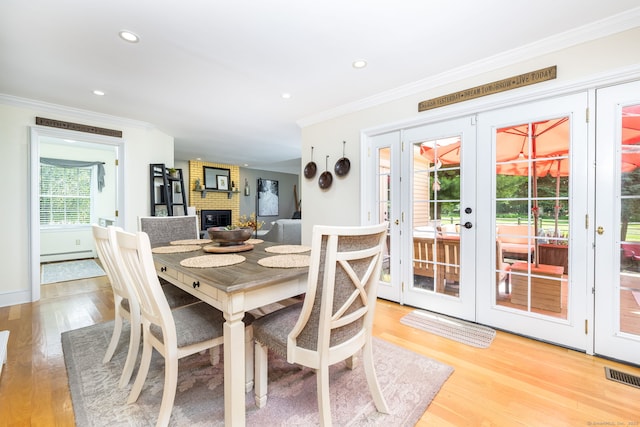 89 Honey Hill Rd, New Hartford, CT 06057 - dining room with crown molding, french doors, light wood-type flooring, a fireplace, and recessed lighting