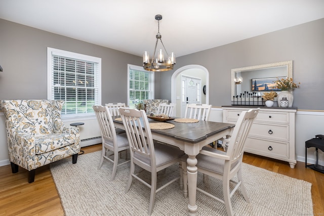 89 Honey Hill Rd, New Hartford, CT 06057 - dining room with arched walkways, light wood-style flooring, a chandelier, and baseboard heating
