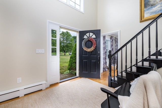 89 Honey Hill Rd, New Hartford, CT 06057 - foyer entrance with healthy amount of natural light, a high ceiling, stairs, and wood finished floors