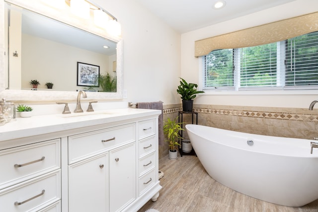 89 Honey Hill Rd, New Hartford, CT 06057 - bathroom featuring tile walls, vanity, a soaking tub, wainscoting, and recessed lighting