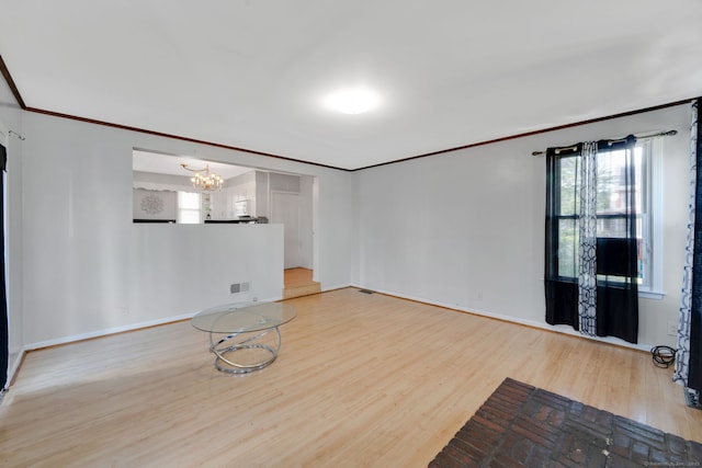 53 Wells Ave, East Hartford, CT 06108 - unfurnished living room featuring ornamental molding, wood finished floors, and a chandelier