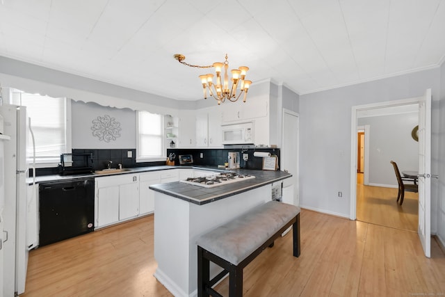 53 Wells Ave, East Hartford, CT 06108 - kitchen with white appliances, a chandelier, white cabinetry, a peninsula, and crown molding