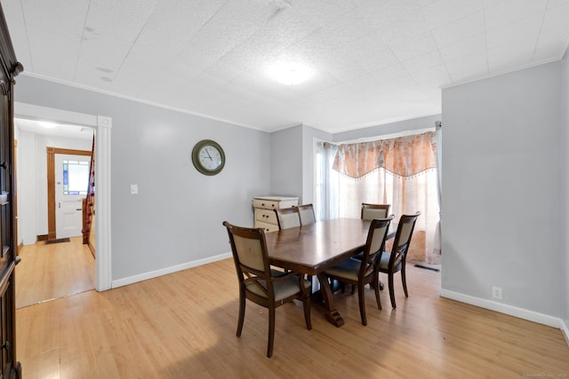 53 Wells Ave, East Hartford, CT 06108 - dining space with light wood-type flooring and crown molding