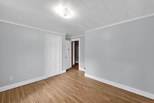 53 Wells Ave, East Hartford, CT 06108 - unfurnished bedroom with wood finished floors, ornamental molding, and a closet