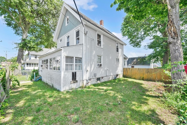 53 Wells Ave, East Hartford, CT 06108 - back of house with a chimney and a fenced backyard
