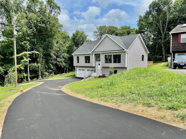 2 Gary Knls, Danbury, CT 06810 - split foyer home with an attached garage, asphalt driveway, and view of scattered trees
