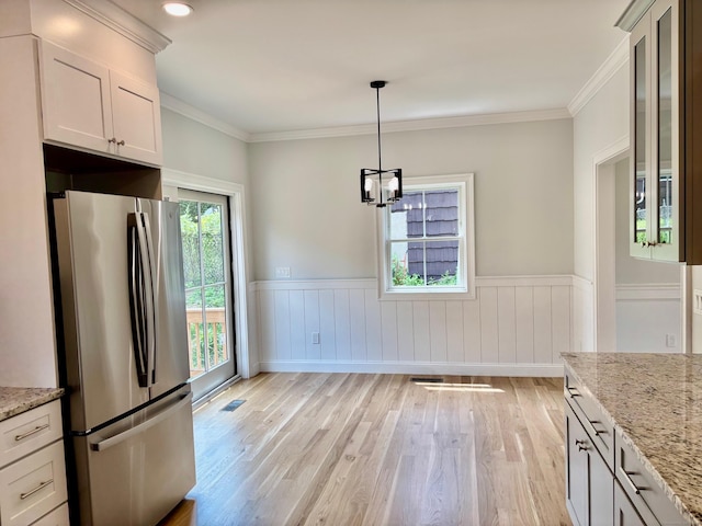 2 Gary Knls, Danbury, CT 06810 - unfurnished dining area featuring light wood finished floors, wainscoting, a chandelier, and ornamental molding