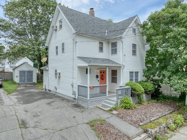 17 Walden Ave, New London, CT 06320 - view of front of property featuring roof with shingles, a porch, a chimney, and a storage unit