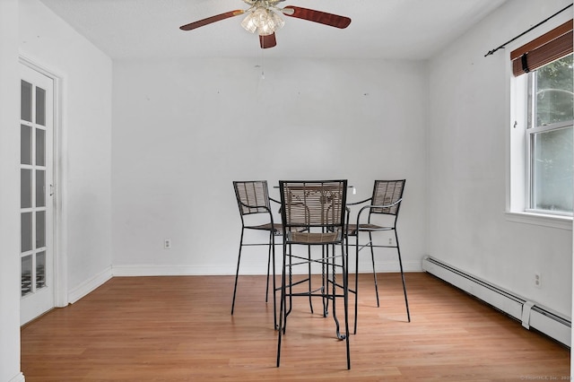 17 Walden Ave, New London, CT 06320 - dining room featuring a baseboard radiator, a ceiling fan, and light wood-style floors