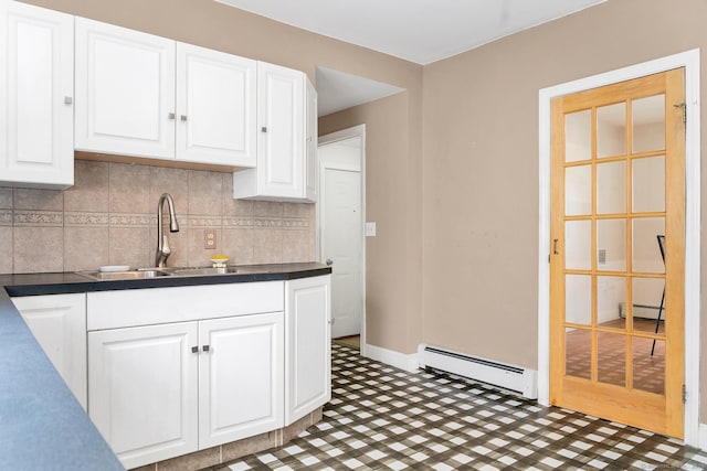 17 Walden Ave, New London, CT 06320 - kitchen with a baseboard radiator, white cabinetry, decorative backsplash, and dark countertops