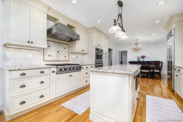 285 Westover Rd, Stamford, CT 06902 - kitchen featuring built in appliances, extractor fan, a chandelier, a kitchen island, and backsplash