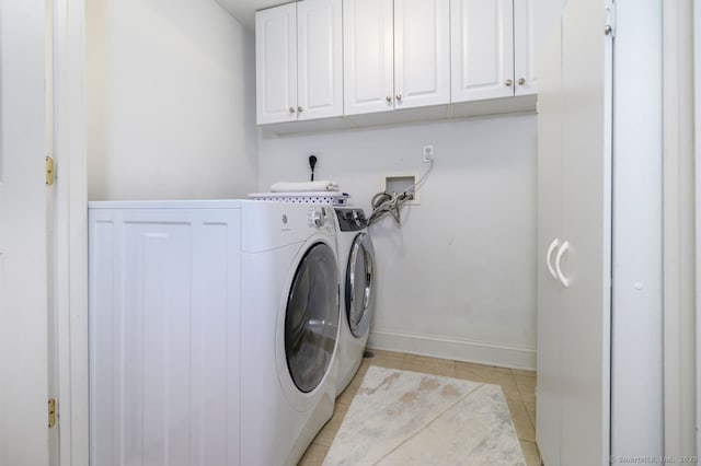 285 Westover Rd, Stamford, CT 06902 - washroom featuring washing machine and clothes dryer, cabinet space, and light tile patterned flooring