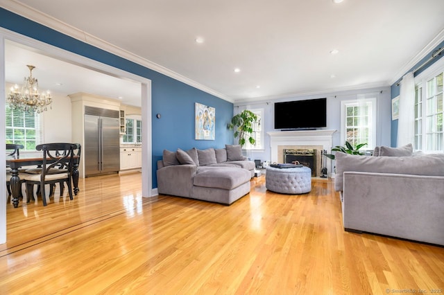 285 Westover Rd, Stamford, CT 06902 - living area featuring a fireplace, light wood-style floors, a chandelier, ornamental molding, and recessed lighting
