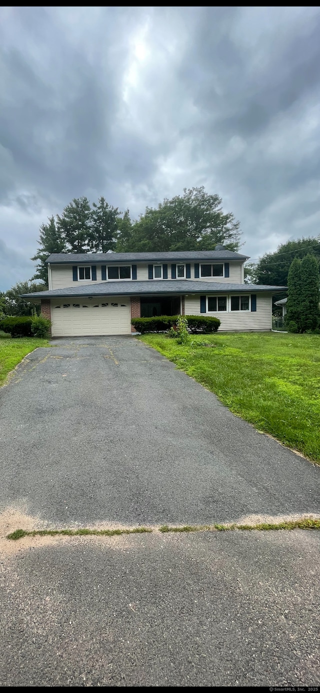 37 W Normandy Dr, West Hartford, CT 06107 - view of front of property with driveway, a front lawn, and a garage