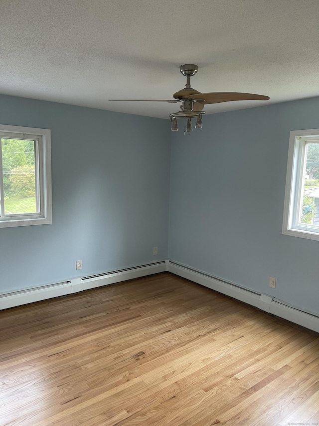 37 W Normandy Dr, West Hartford, CT 06107 - empty room featuring ceiling fan, light wood-style flooring, a baseboard radiator, and a textured ceiling