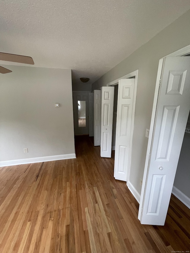 37 W Normandy Dr, West Hartford, CT 06107 - empty room with wood finished floors, a textured ceiling, and a ceiling fan