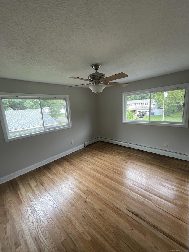 37 W Normandy Dr, West Hartford, CT 06107 - empty room with baseboard heating, ceiling fan, wood finished floors, and a textured ceiling